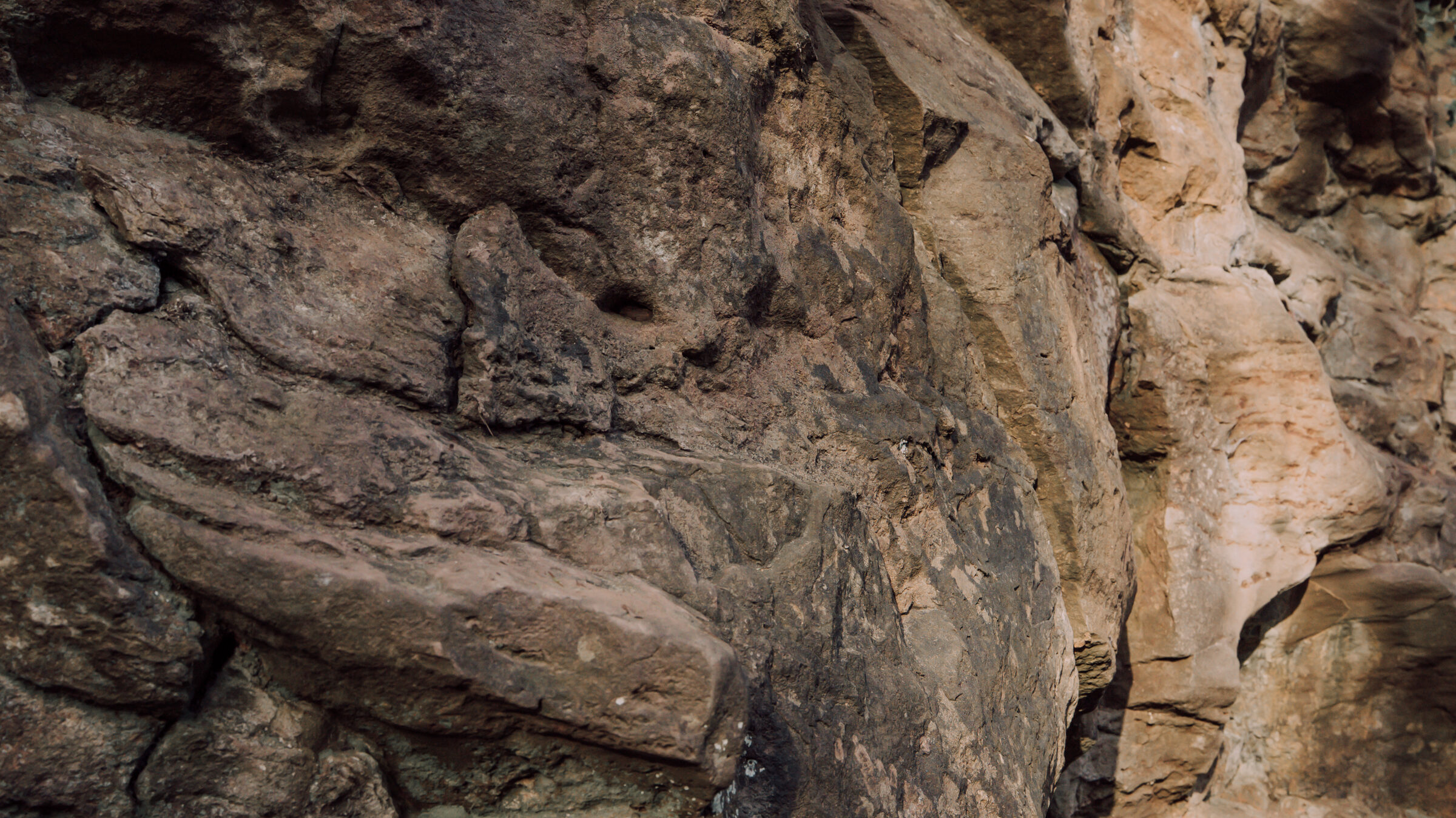 Weathered sandstone face, layered and orange