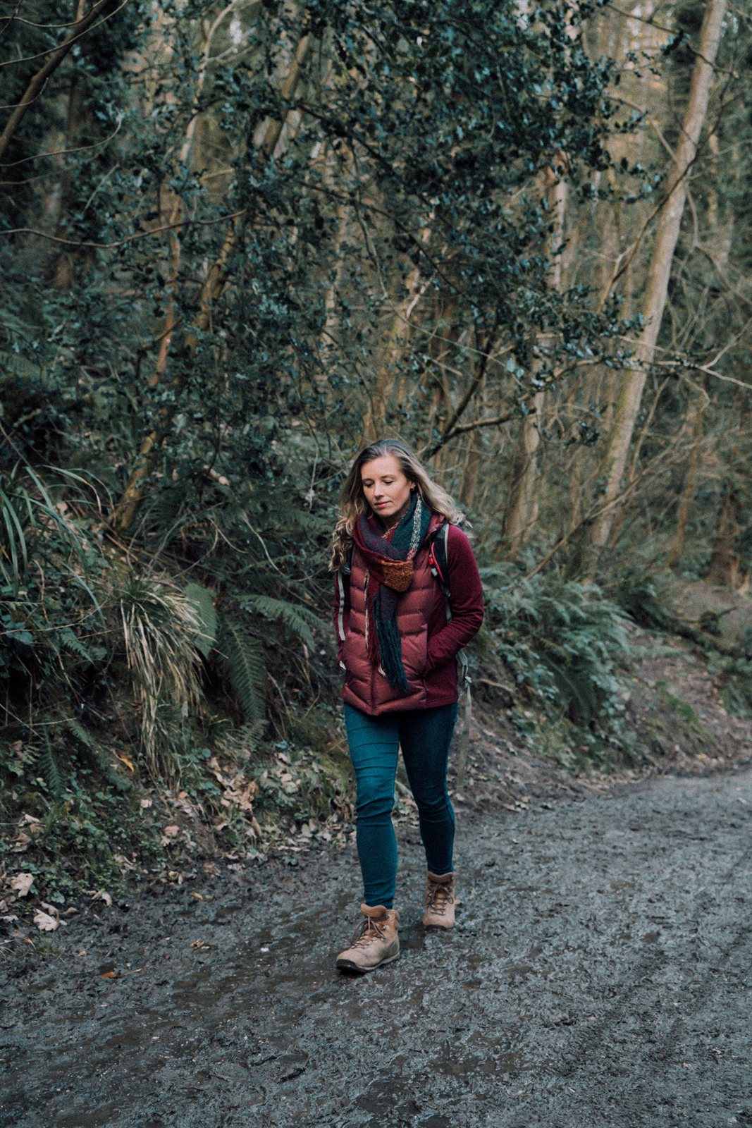 Libby walking along a muddy woodland path